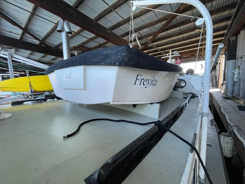 Slide: The Image of 1940 Historic Tacoma Boat Co Cruiser docked in a covered marina. - 40