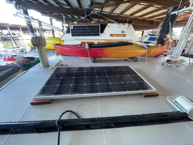 Slide: The Image of 1940 Historic Tacoma Boat Co Cruiser with solar panels and kayak on deck. - 41
