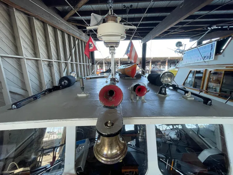 Slide: The Image of 1940 Historic Tacoma Boat Co Cruiser with flags and nautical equipment on deck. - 44