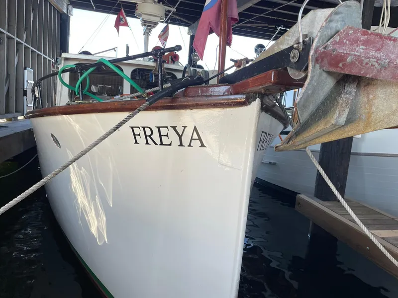 Slide: The Image of 1940 Historic Tacoma Boat Co Cruiser "Freya" docked, showcasing classic design and craftsmanship. - 48