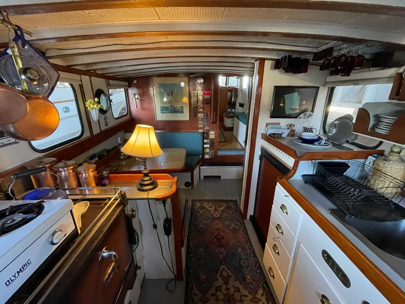 Slide: The Image of Interior of a 1940 Historic Tacoma Boat Co Cruiser with vintage decor and kitchen setup. - 5