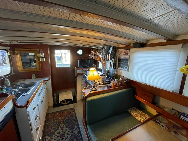 Slide: The Image of Interior of a 1940 Historic Tacoma Boat Co Cruiser with vintage decor and cozy seating. - 6