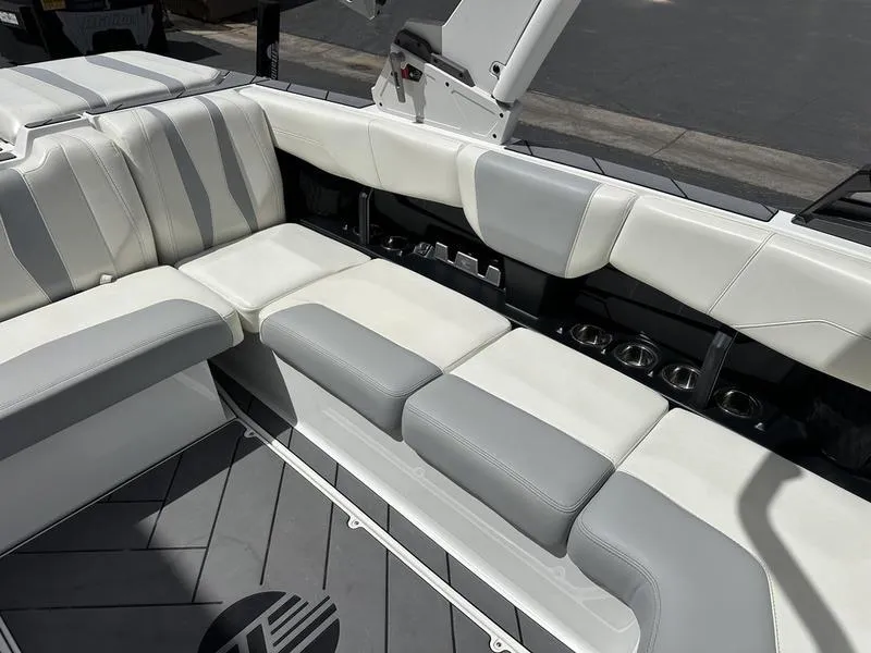 Slide: The Image of 2023 Malibu 22 LSV boat interior with white and gray seating. - 13
