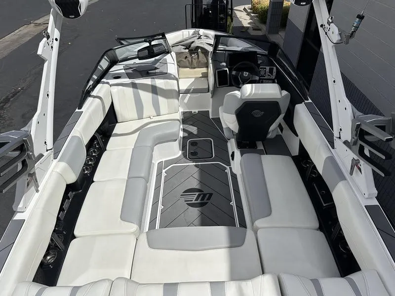 Slide: The Image of 2023 Malibu 22 LSV boat interior with white seating and sleek design. - 14
