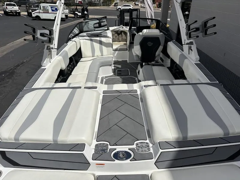 Slide: The Image of 2023 Malibu 22 LSV boat interior with sleek white and gray seating design. - 17
