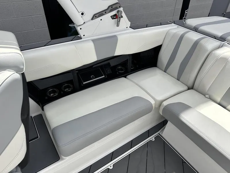 Slide: The Image of 2023 Malibu 22 LSV boat interior with sleek gray and white seating. - 18