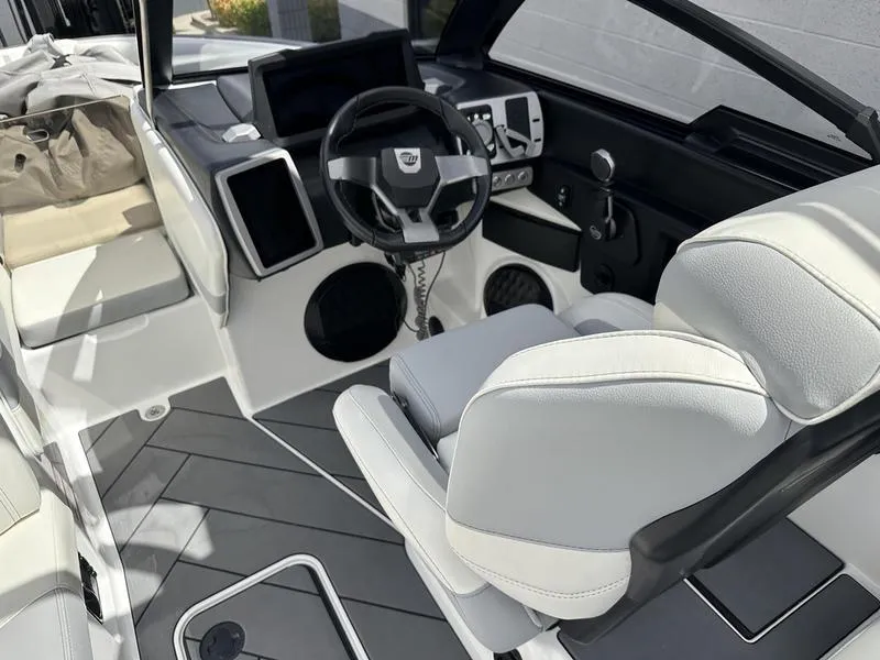 Slide: The Image of 2023 Malibu 22 LSV boat interior with modern dashboard and seating. - 19