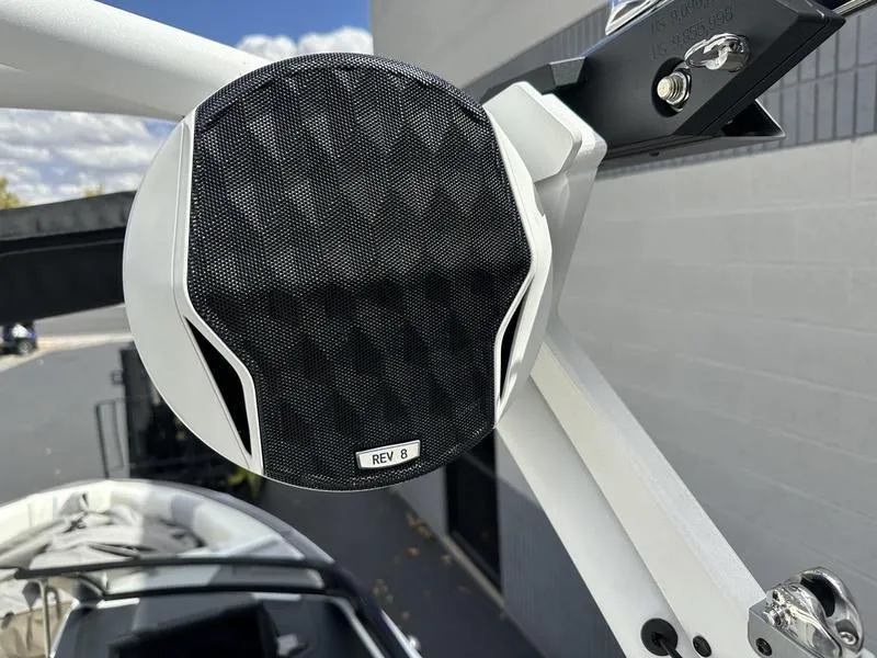 Slide: The Image of Close-up of a 2023 Malibu 22 LSV boat speaker, mounted on a white frame. - 22