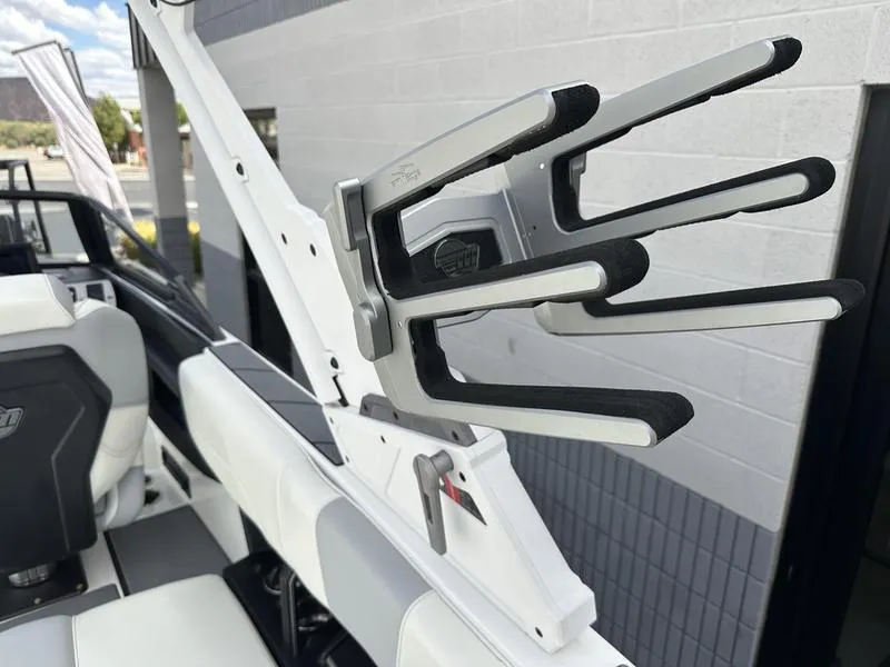 Slide: The Image of 2023 Malibu 22 LSV boat with wakeboard rack and sleek interior design. - 5