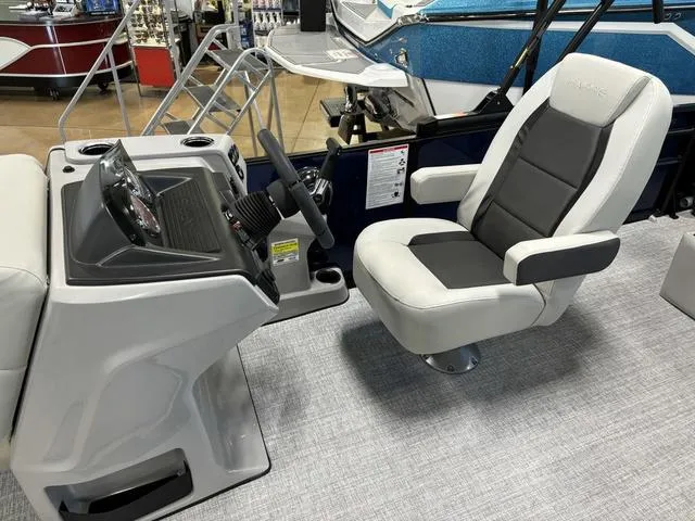 Slide: The Image of 2025 Harris CRUISER 230 SLDH boat interior with captain's chair and control console. - 11