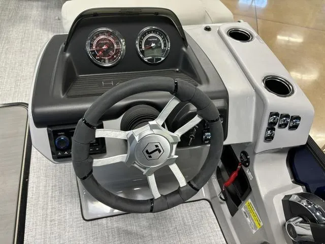 Slide: The Image of Steering console of 2025 Harris CRUISER 230 SLDH with gauges and controls. - 12