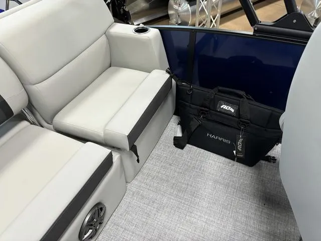 Slide: The Image of 2025 Harris CRUISER 230 SLDH interior with gray seating and storage bag. - 15