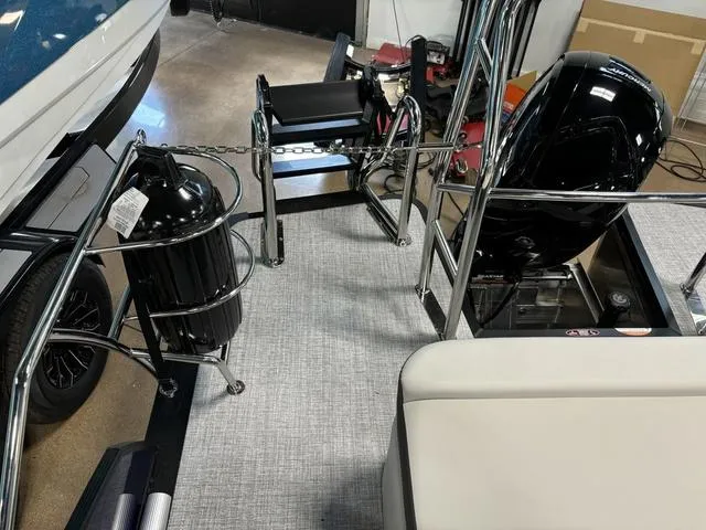 Slide: The Image of 2025 Harris CRUISER 230 SLDH boat interior with motor and seating area. - 19