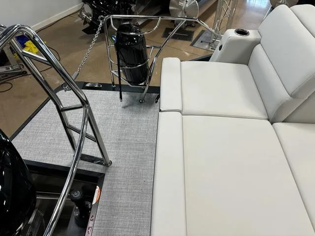 Slide: The Image of 2025 Harris CRUISER 230 SLDH boat interior with white seating and stainless steel railings. - 20