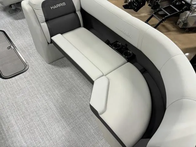 Slide: The Image of 2025 Harris CRUISER 230 SLDH boat interior with plush seating and cup holders. - 6