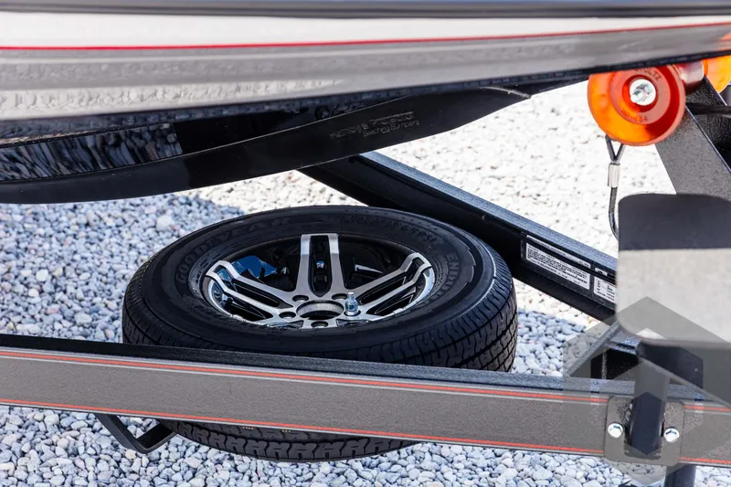Slide: The Image of Skeeter ZXR 21 trailer with spare tire, 2025 model, on gravel surface. - 10