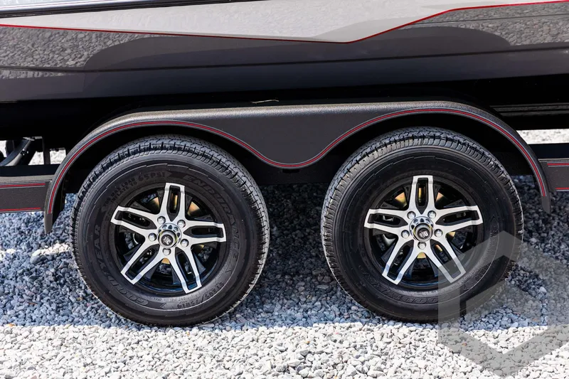 Slide: The Image of 2025 Skeeter ZXR 21 trailer wheels on gravel surface. - 12