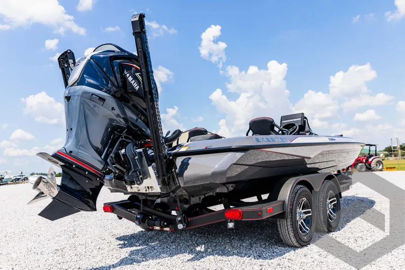 Slide: The Image of 2025 Skeeter ZXR 21 boat on trailer, featuring powerful outboard motor, under clear blue sky. - 13