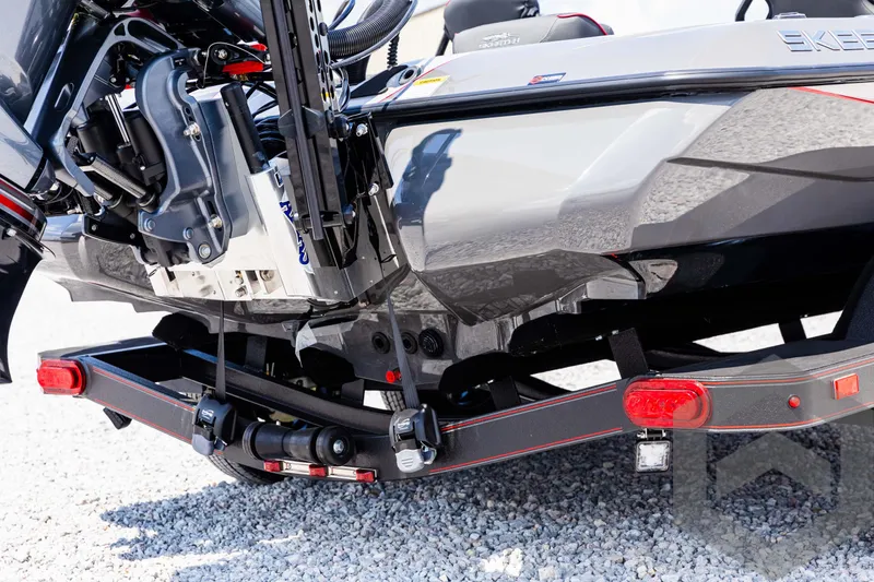 Slide: The Image of 2025 Skeeter ZXR 21 boat on trailer, detailed view of engine and hull. - 14