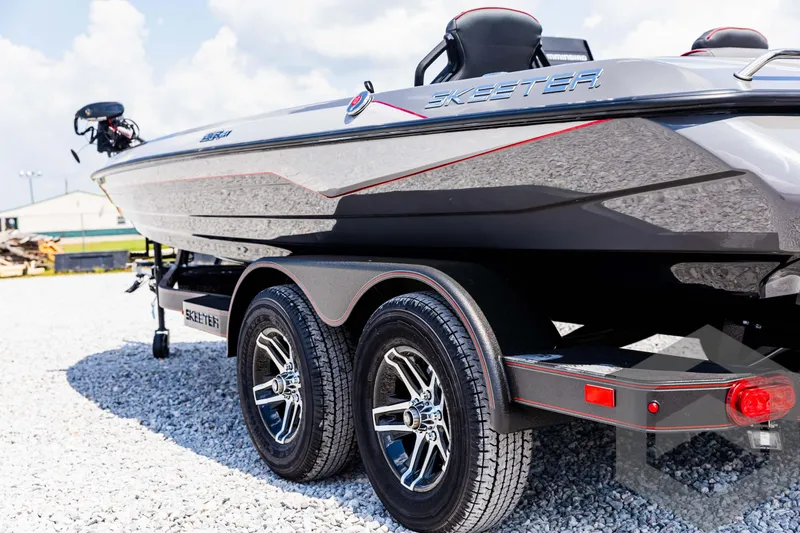 Slide: The Image of 2025 Skeeter ZXR 21 boat on trailer, showcasing sleek design and dual wheels. - 19