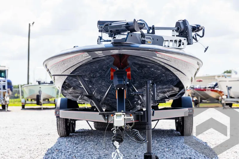 Slide: The Image of 2025 Skeeter ZXR 21 boat on trailer, front view, parked on gravel lot. - 2