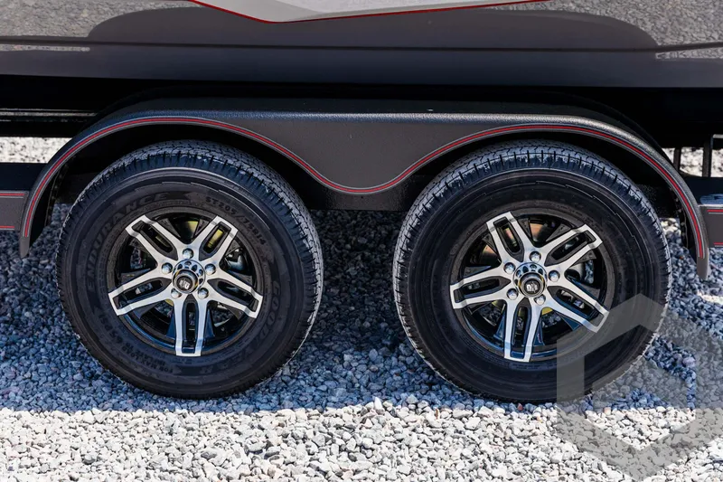 Slide: The Image of 2025 Skeeter ZXR 21 trailer wheels on gravel surface. - 22