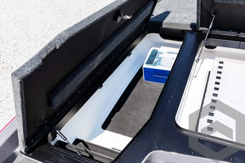 Slide: The Image of Open storage compartment in 2025 Skeeter ZXR 21 boat, featuring organized interior space. - 29