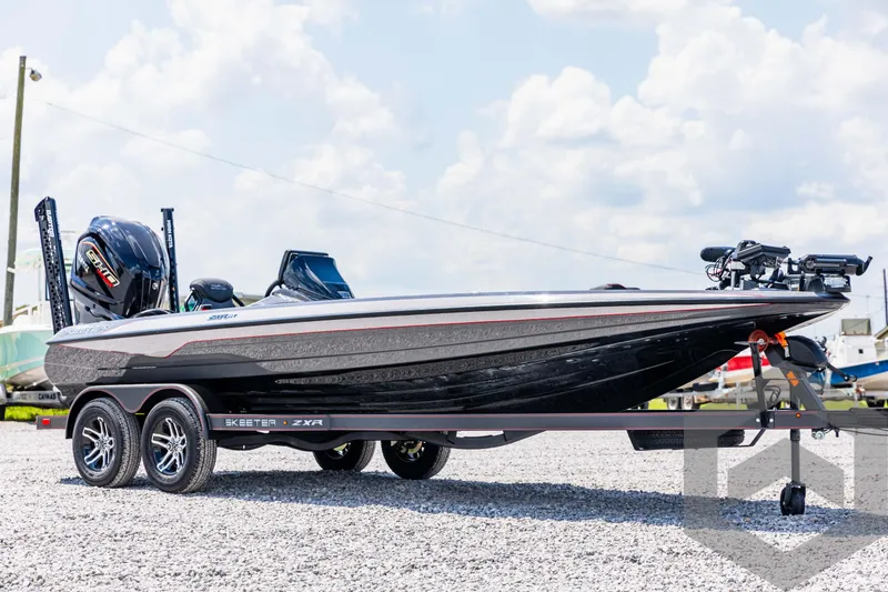 Slide: The Image of 2025 Skeeter ZXR 21 boat on trailer, parked outdoors under cloudy sky. - 3