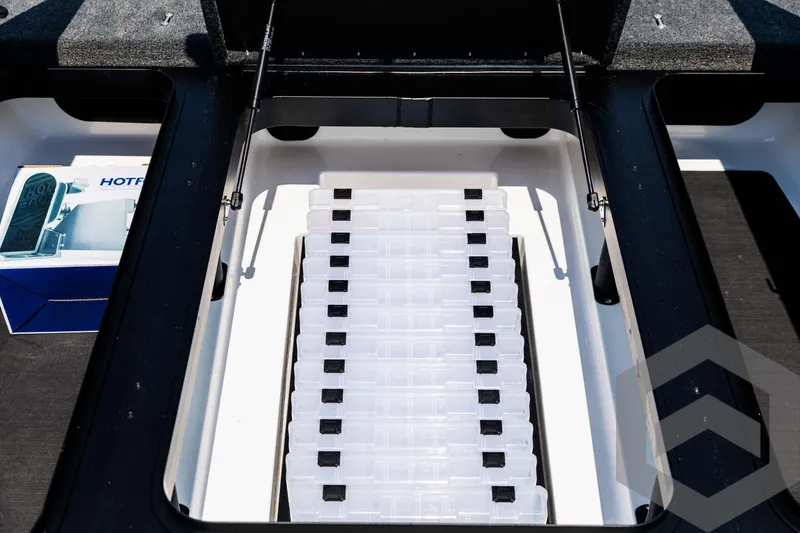 Slide: The Image of Skeeter ZXR 21 boat storage compartment, 2025 model, with organized tackle boxes. - 30