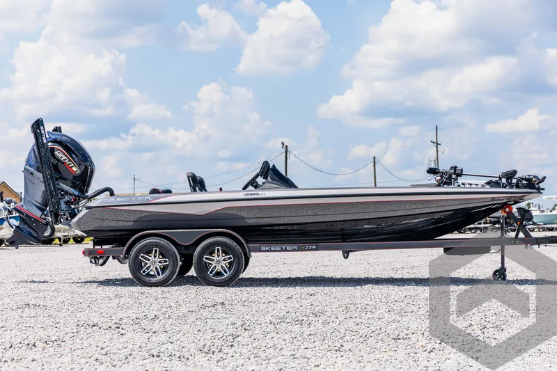 Slide: The Image of 2025 Skeeter ZXR 21 boat on trailer, parked on gravel, under a cloudy sky. - 4