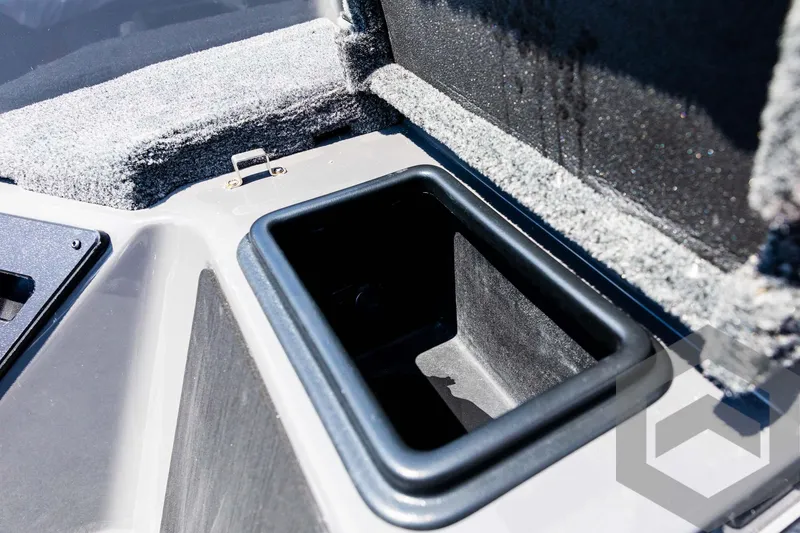 Slide: The Image of 2025 Skeeter ZXR 21 boat storage compartment with carpeted interior. - 40