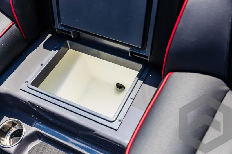 Slide: The Image of 2025 Skeeter ZXR 21 boat storage compartment with sleek black and red seating. - 47