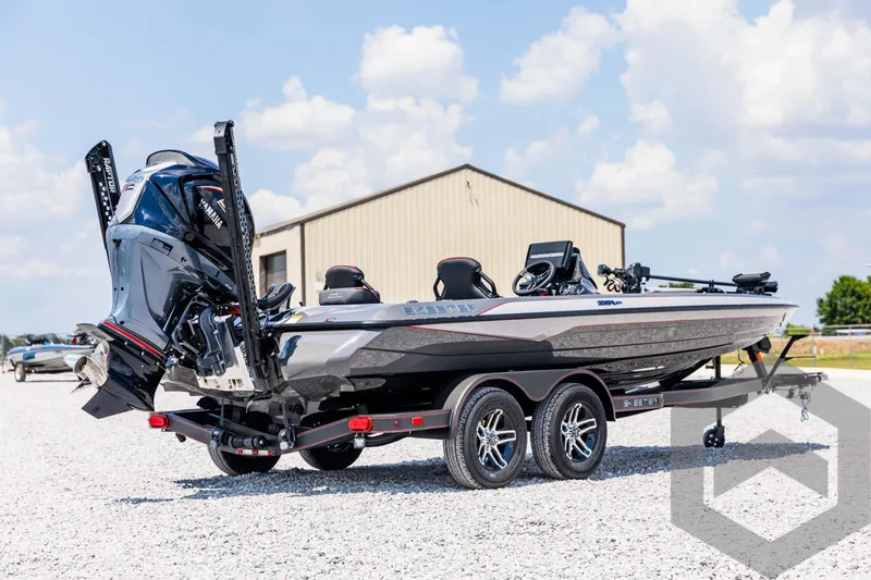 Slide: The Image of 2025 Skeeter ZXR 21 boat on trailer, parked outdoors under a cloudy sky. - 5