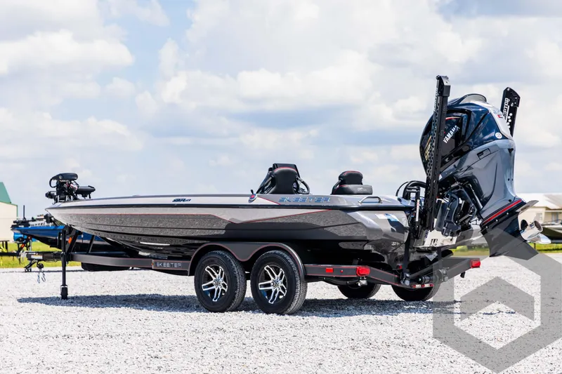 Slide: The Image of 2025 Skeeter ZXR 21 boat on trailer, sleek design, dual motors, parked on gravel. - 7