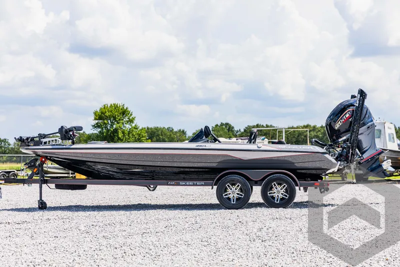 Slide: The Image of 2025 Skeeter ZXR 21 boat on trailer, parked outdoors under a cloudy sky. - 8