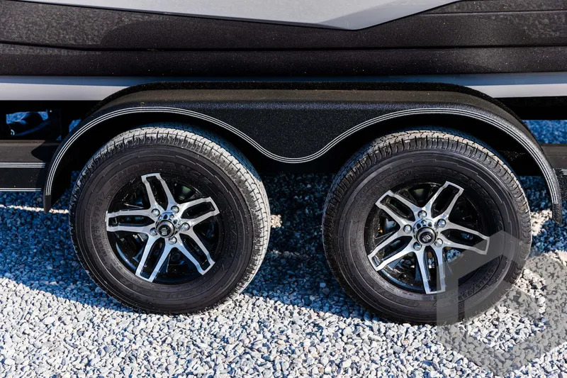 Slide: The Image of 2025 Skeeter ZXR 20 trailer wheels on gravel surface. - 12