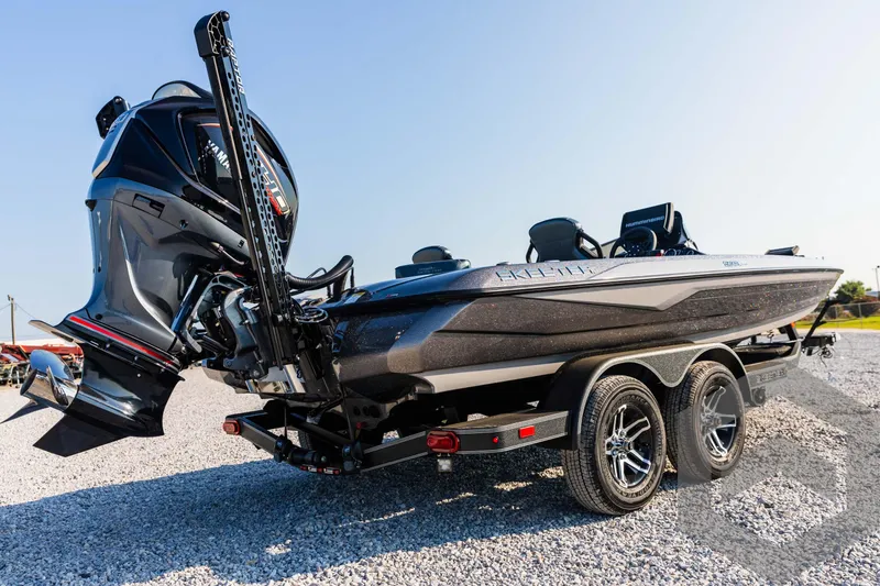 Slide: The Image of 2025 Skeeter ZXR 20 boat on trailer, sleek design, powerful engine, sunny day. - 13