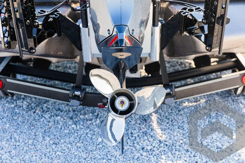 Slide: The Image of Close-up of a 2025 Skeeter ZXR 20 boat propeller on gravel surface. - 15