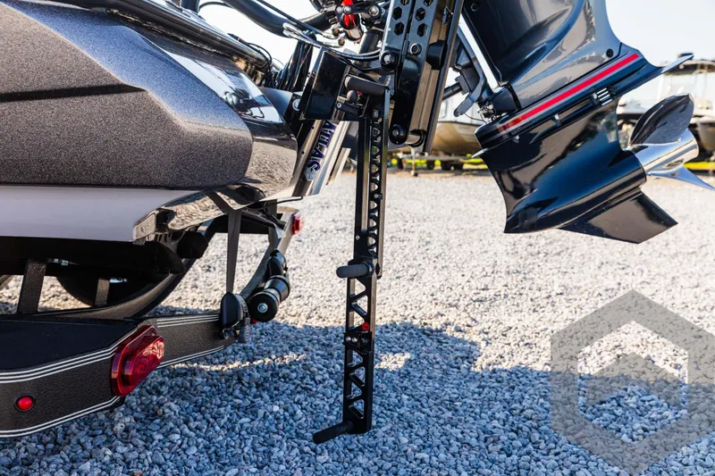 Slide: The Image of 2025 Skeeter ZXR 20 boat trailer with motor mount on gravel surface. - 20