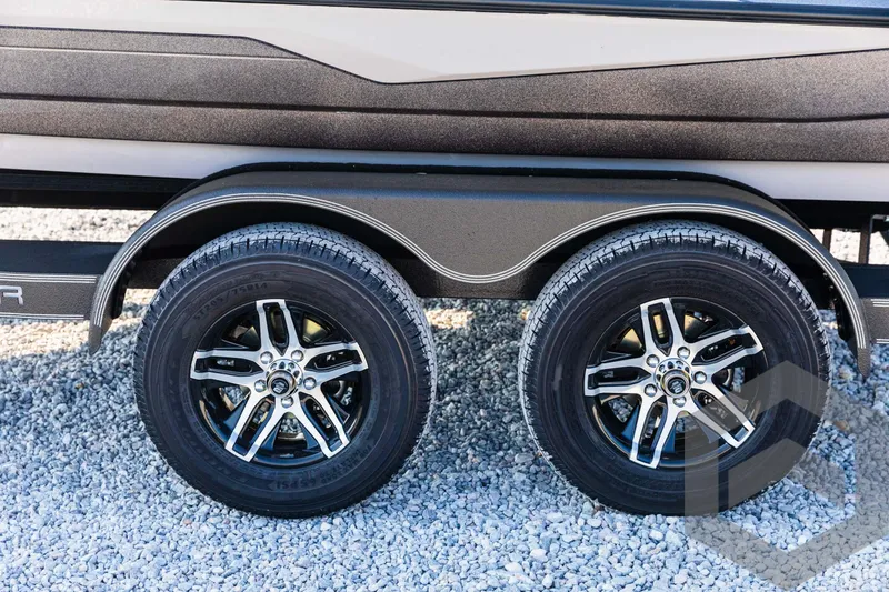 Slide: The Image of 2025 Skeeter ZXR 20 trailer wheels on gravel surface. - 21