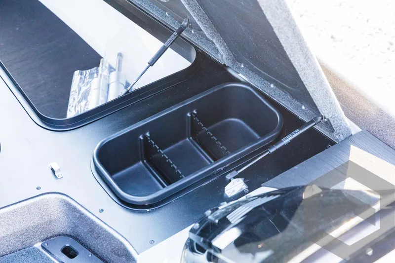 Slide: The Image of 2025 Skeeter ZXR 20 boat storage compartment with open lid and organized interior. - 33
