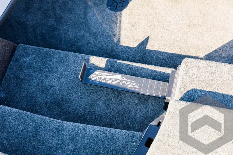 Slide: The Image of 2025 Skeeter ZXR 20 boat interior with custom carpet and logo detail. - 43