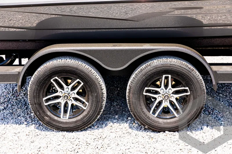 Slide: The Image of 2025 Skeeter ZXR 20 trailer wheels on gravel surface. - 12