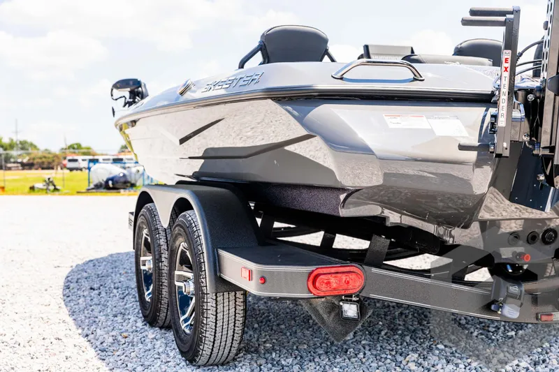 Slide: The Image of 2025 Skeeter ZXR 20 boat on trailer, parked on gravel. - 22