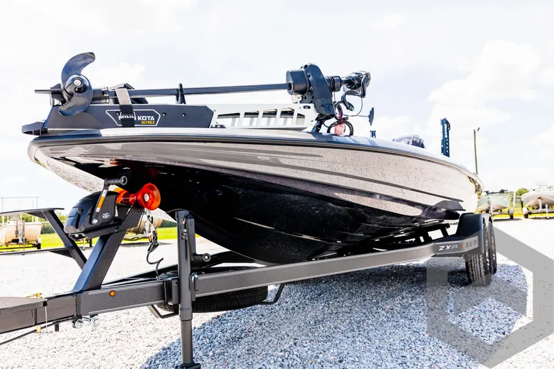 Slide: The Image of 2025 Skeeter ZXR 20 boat on trailer, displayed outdoors on gravel. - 25