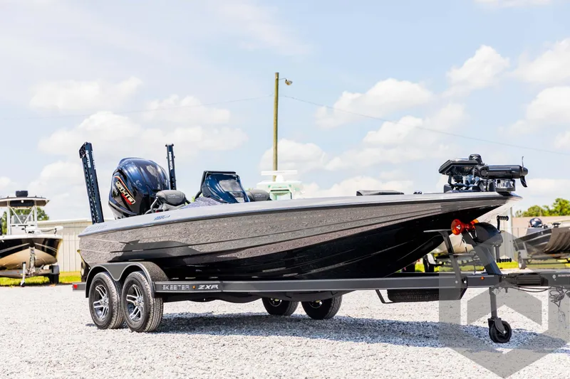 Slide: The Image of 2025 Skeeter ZXR 20 boat on trailer, parked outdoors under a clear sky. - 3