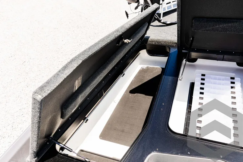 Slide: The Image of 2025 Skeeter ZXR 20 boat storage compartment with open lid, showcasing interior design. - 30