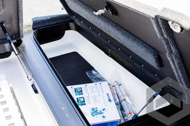 Slide: The Image of Open storage compartment of 2025 Skeeter ZXR 20 boat with accessories inside. - 32