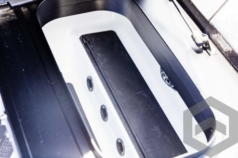 Slide: The Image of 2025 Skeeter ZXR 20 boat storage compartment with sleek black and white design. - 34