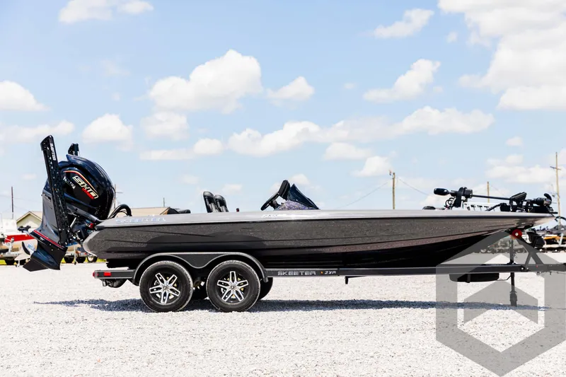Slide: The Image of 2025 Skeeter ZXR 20 boat on trailer under blue sky. - 4